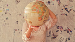Woman globe wall of newspapers - front of a wall free wallpaper