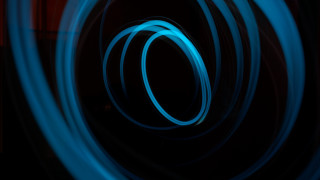 Blue light painting circular hologram - a blue light in the middle of the image free wallpaper