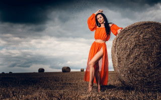 Woman orange dress haybale cloudy - an orange dress free wallpaper