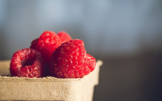 Raspberries box table blurry background - a table top free wallpaper