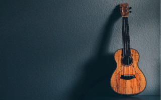 Ukulele hanging blue wall black - a black wall free wallpaper