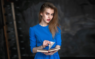 Surprised woman blue dress reading - a blue dress holding free wallpaper