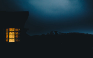 Window lit dark night sky - a building in the foreground free wallpaper