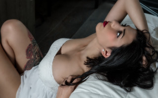 Woman tattoo bed blackhair lying - her arm and chest free wallpaper