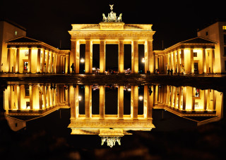 Building reflection water night person - perfect symmetry free wallpaper