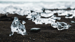 Ice crystals beach rock aurora - the background and a rock in the foreground free wallpaper