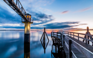 Pier lighthouse sunset clouds reflection - a light house free wallpaper