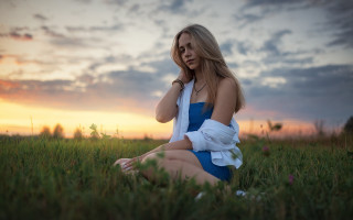 Woman field blue dress sitting - a field of grass free wallpaper