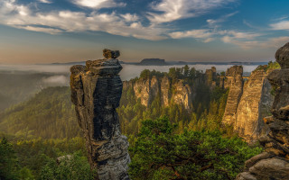 Mountain cliff trees foggy sky - a view of a mountain free wallpaper