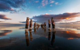Wooden posts water sunset clouds - symmetrical free wallpaper
