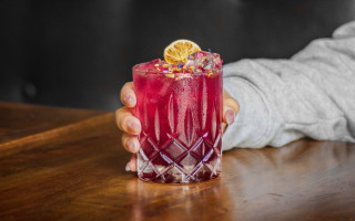 Person holding drink wooden table - a drink free wallpaper