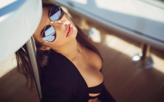 Woman sunglasses leaning wall blurry - against a wall free wallpaper