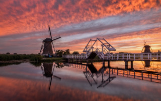 Windmill bridge reflection sunset landscape - a colorful sky in the background free wallpaper