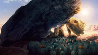Cartoon character hiding behind rock - a large rock formation in the foreground free wallpaper