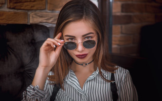 Woman glasses necklace sunglasses brick - a brick wall in the background free wallpaper