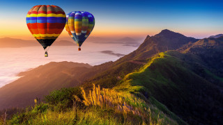 Hot air balloons mountain sunset - over a mountain range free wallpaper