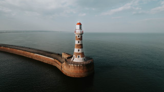 Lighthouse ocean cloudy sky tilt - a lighthouse free wallpaper