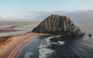 Large rock beach ocean boat - a large rock free wallpaper