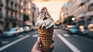 Person holding icecream city street - food photography free wallpaper