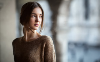 Woman brown sweater serious portrait 2 - a brown sweater free wallpaper