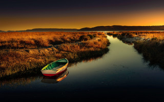 Marshy boat sunset mountain cinematic - a mountain range in the background free wallpaper
