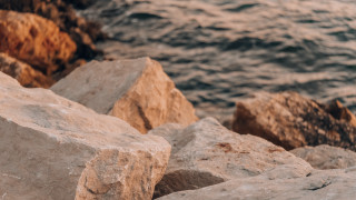 Bird rock ocean mountains shore - deep free wallpaper