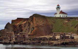 Lighthouse cliff ocean rocky shore - the water and a boat free wallpaper