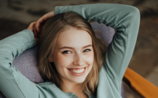 Woman smiling blonde portrait stock - her arm behind her head free wallpaper for desktop