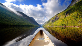 Tranquil boat river mountains clouds - eric deschamps free wallpaper