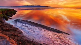 Sunset water island mountain city - a sunset over a body of water free wallpaper for desktop