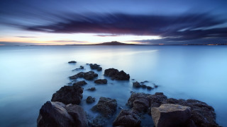 Rocky beach dusk mountain water - free beach wallpaper
