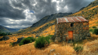 Small stone building mountains cloudy - great free wallpaper