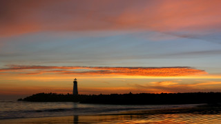 Lighthouse island ocean sunset red - a red sky in the background free wallpaper