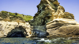 Ocean rock formation cliff person - a cave painting free wallpaper for desktop