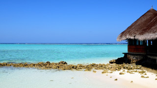 Beach hut blue ocean rock - a blue ocean in the background free wallpaper
