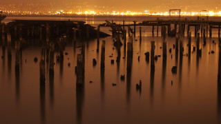 Water poles city sunset twilight - side and a city in the background free wallpaper for desktop