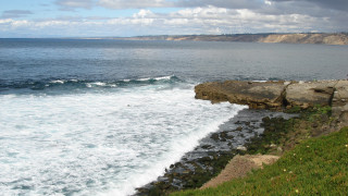 Rocky cliff ocean cloudy panorama - a rocky cliff free wallpaper