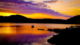 Lake sunset mountains boat person - the background and a person free wallpaper