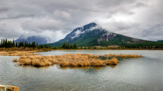 Mountain lake grass cloudy sky - a cloudy sky above free wallpaper