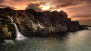 Waterfall over ocean sunset mountain - water free wallpaper for desktop