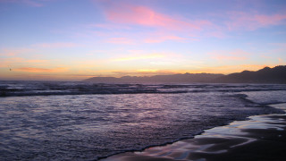 Sunset ocean waves mountains city - a sunset over the ocean free wallpaper for desktop