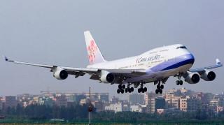 Jetliner cloudy sky city skyline - tail free wallpaper