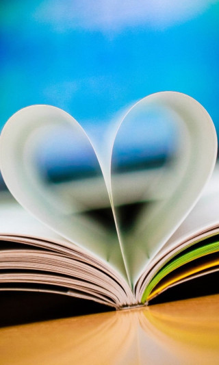 Book heart pages table blurry - a blurry background free wallpaper for mobile