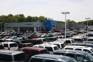 Cars parked building sky trees - a sky background and trees free wallpaper