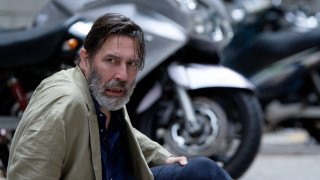 Man sitting ground motorcycle behind - movie still free wallpaper