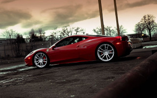 Red sports car parked street 3 - a cloudy sky in the background free wallpaper