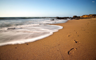 Beach waves person walking rock - free beach wallpaper