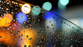 Rainy window city bubbles moon - a close up of a rain free wallpaper