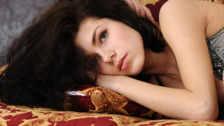 Woman laying bed hand head 4 - free portrait wallpaper