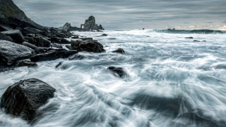 Rocky beach waves lighthouse clouds - a rocky beach free wallpaper